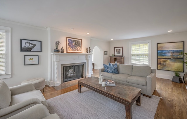 living room with ornamental molding and hardwood / wood-style floors