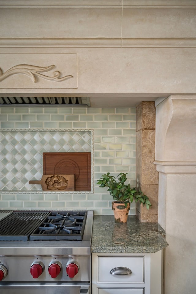 kitchen with tasteful backsplash and high end stainless steel range