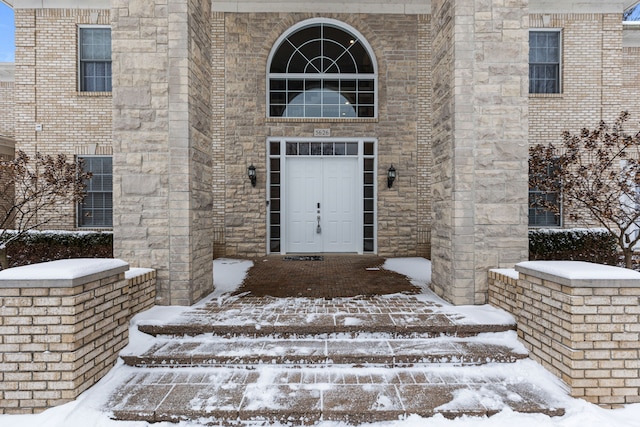 view of snow covered property entrance