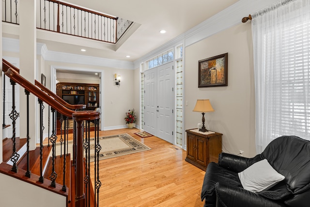 foyer featuring crown molding and hardwood / wood-style flooring