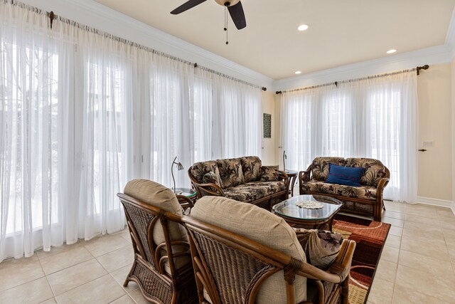 living room featuring crown molding, light tile patterned floors, and ceiling fan