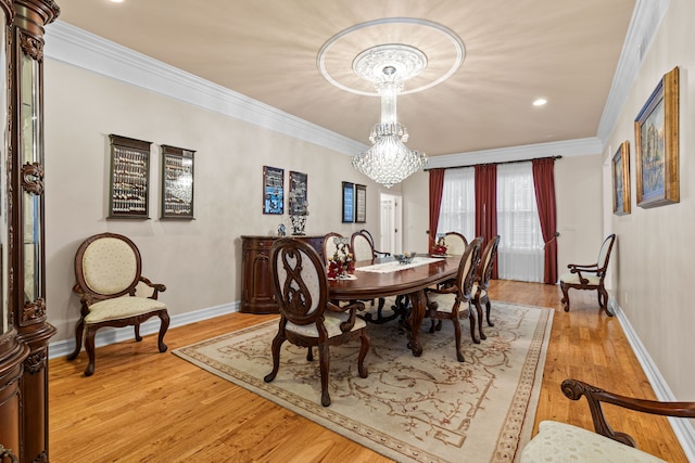 dining space with crown molding, a notable chandelier, and light wood-type flooring