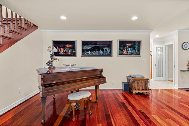 miscellaneous room with crown molding and hardwood / wood-style flooring