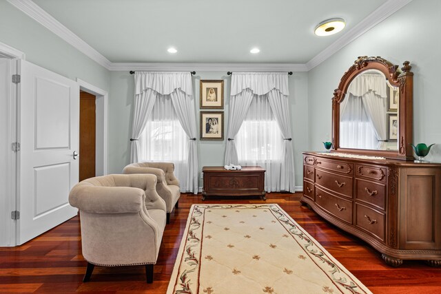 sitting room featuring ornamental molding and dark hardwood / wood-style floors