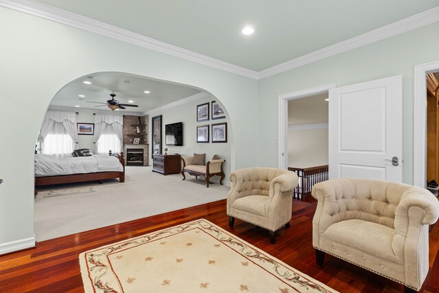 bedroom featuring crown molding, dark hardwood / wood-style floors, and ceiling fan