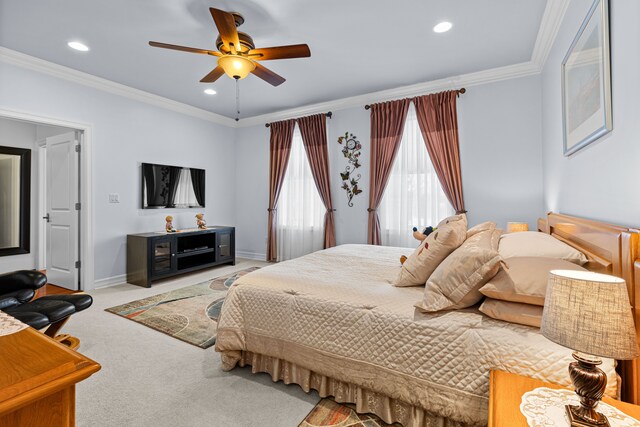 carpeted bedroom with crown molding and ceiling fan