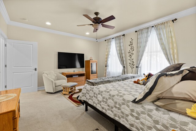 carpeted bedroom with ornamental molding and ceiling fan