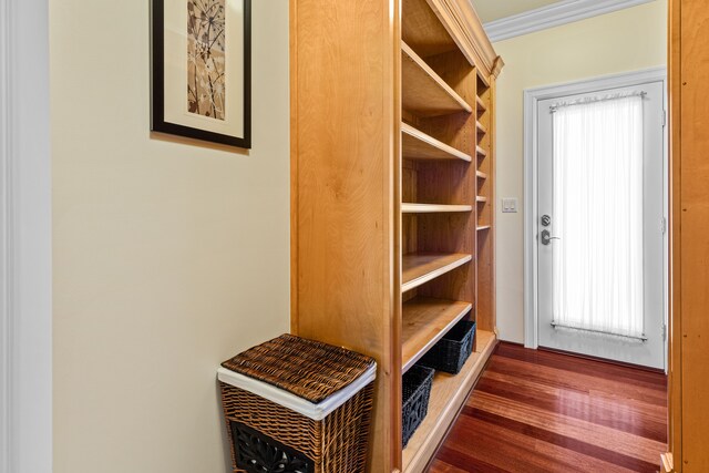 mudroom with ornamental molding and dark hardwood / wood-style floors