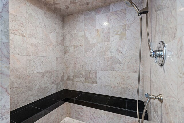 bathroom with tiled shower