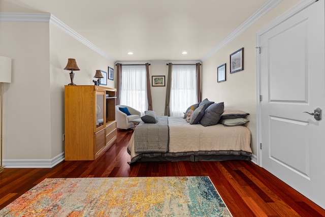 bedroom with ornamental molding and dark hardwood / wood-style flooring