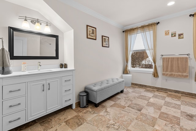 bathroom with ornamental molding and vanity