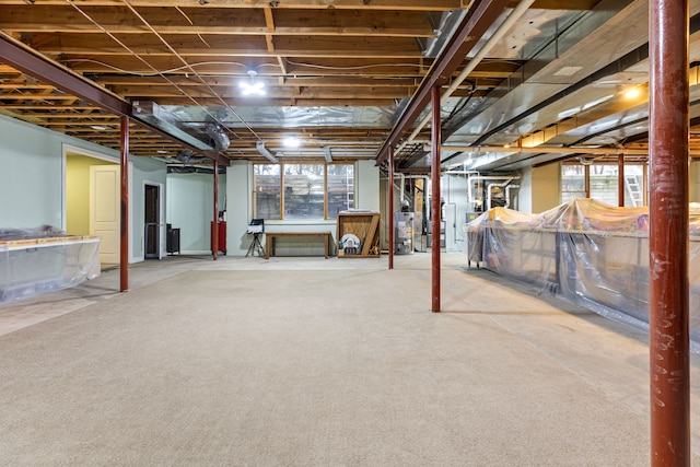 basement with water heater and carpet