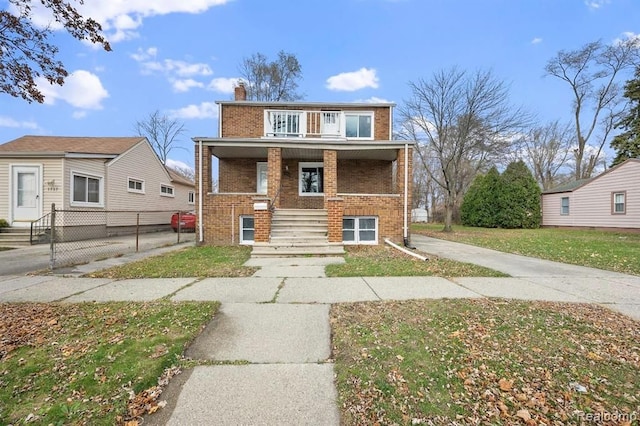 view of front of home featuring covered porch and a front yard