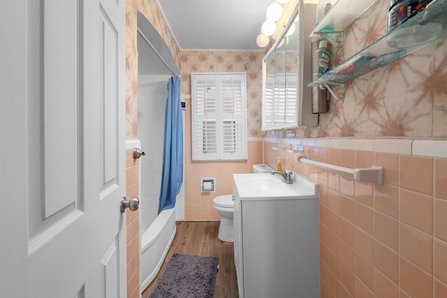 full bathroom featuring shower / tub combo, tile walls, vanity, wood-type flooring, and toilet