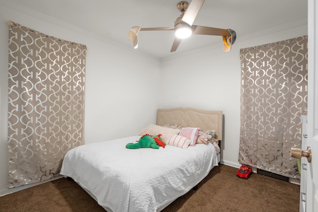 carpeted bedroom with ceiling fan and ornamental molding