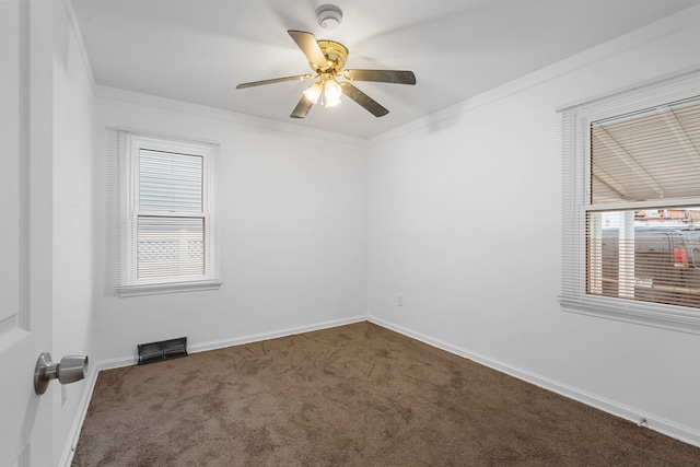 carpeted spare room featuring crown molding and ceiling fan