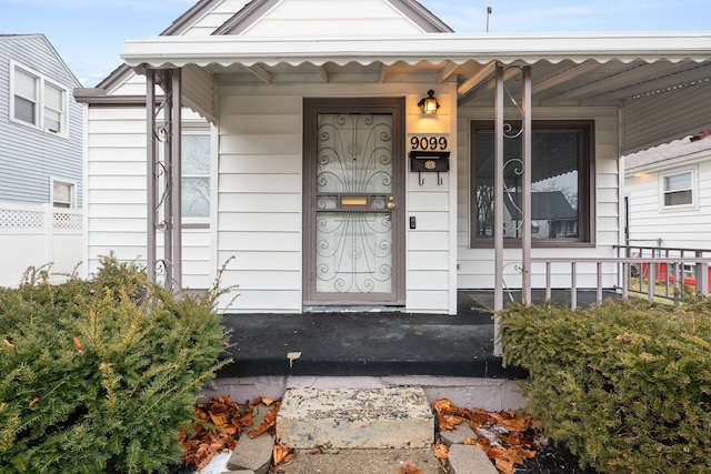 view of exterior entry with a porch