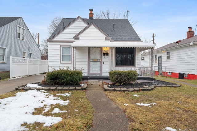 bungalow featuring a front lawn and a porch