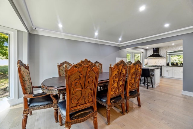 dining room featuring light hardwood / wood-style flooring and ornamental molding