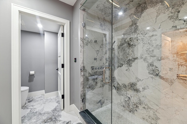 bathroom featuring toilet and a shower with door