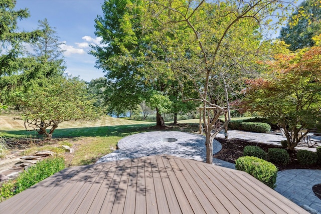 wooden terrace with a patio area and a lawn