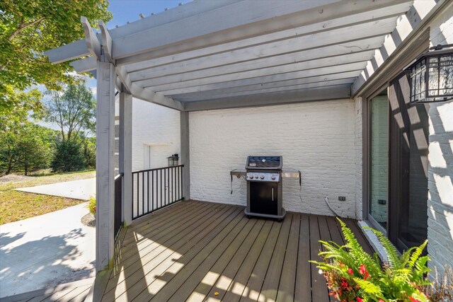 wooden terrace with grilling area and a pergola