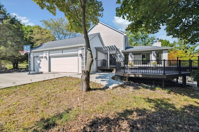 view of front of home with a garage, a wooden deck, a front yard, and a pergola