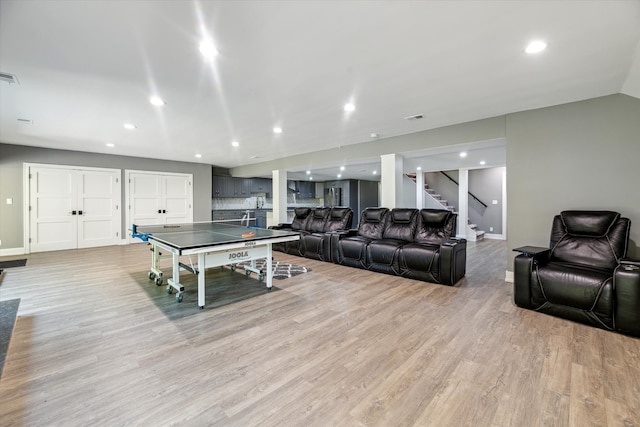 rec room featuring lofted ceiling and light hardwood / wood-style floors