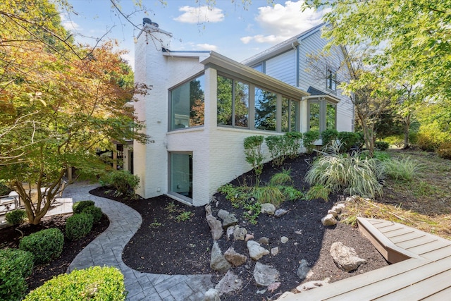 view of side of property featuring a sunroom