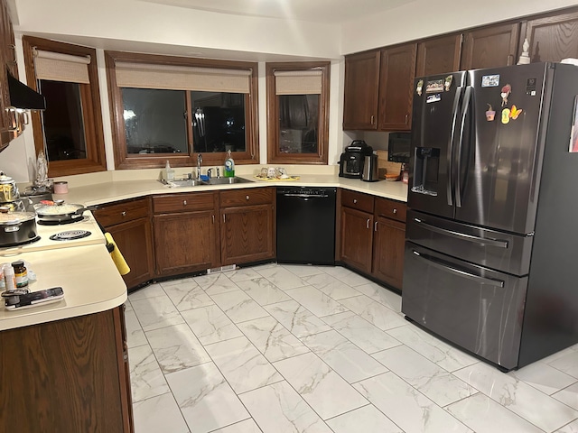 kitchen featuring stainless steel refrigerator with ice dispenser, black dishwasher, and sink