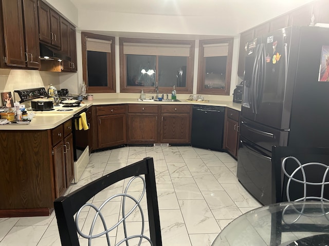 kitchen with sink, dark brown cabinets, and black appliances