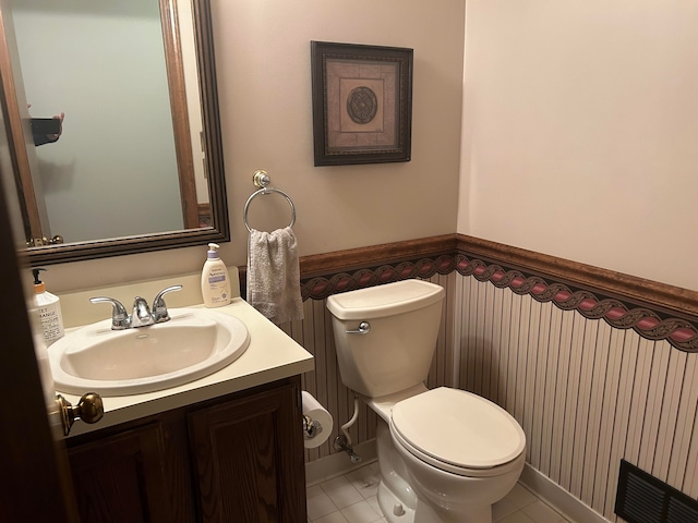 bathroom featuring vanity, toilet, and tile patterned flooring