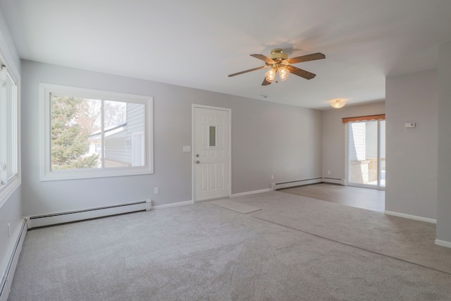 carpeted spare room featuring ceiling fan and a baseboard radiator