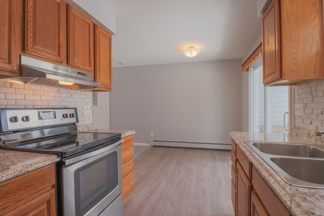 kitchen with sink, baseboard heating, electric range, decorative backsplash, and light wood-type flooring