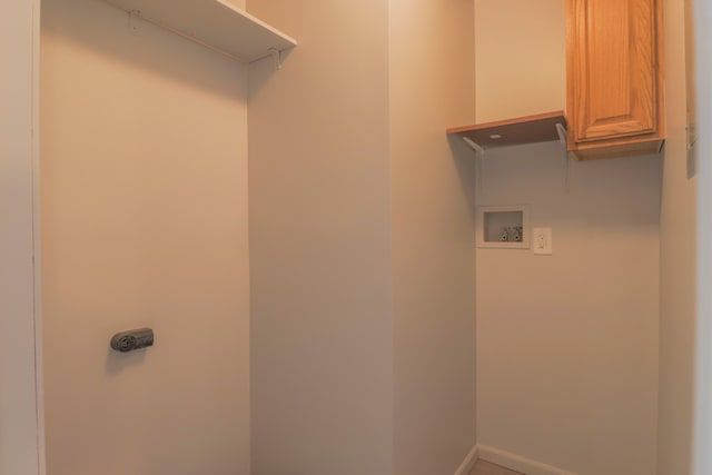 laundry area featuring washer hookup and cabinets