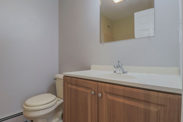 bathroom with vanity, toilet, and a baseboard heating unit