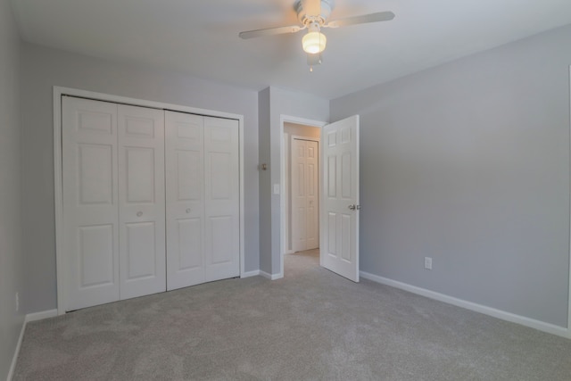 unfurnished bedroom featuring light colored carpet, ceiling fan, and a closet