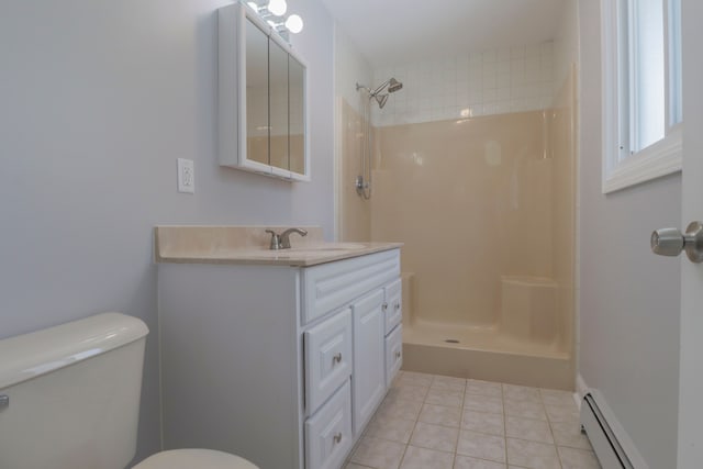 bathroom with tile patterned flooring, tiled shower, vanity, a baseboard radiator, and toilet