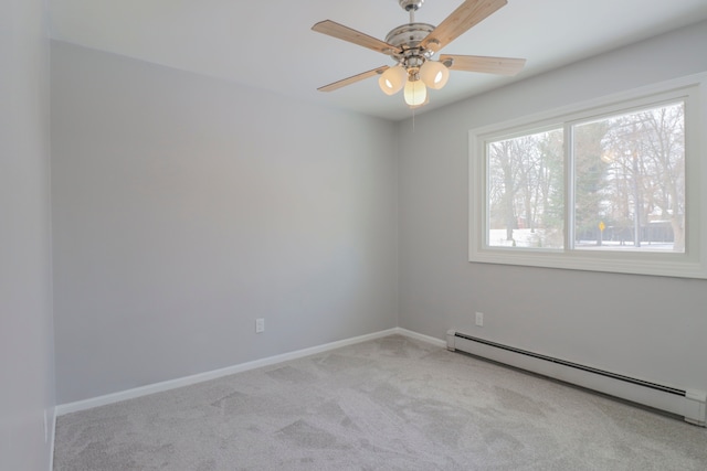 unfurnished room featuring ceiling fan, light colored carpet, and a baseboard heating unit