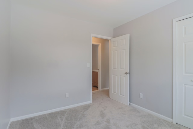 unfurnished bedroom with light carpet