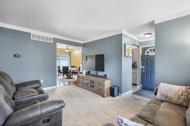 living room with crown molding, light carpet, and ceiling fan