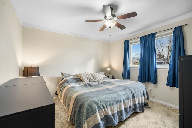 carpeted bedroom featuring ceiling fan and ornamental molding