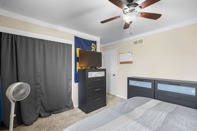 bedroom with ceiling fan, light colored carpet, and ornamental molding