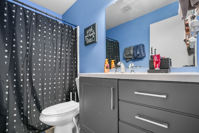 bathroom featuring vanity, toilet, and a shower with shower curtain