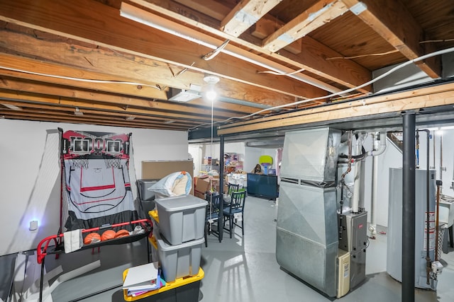 basement featuring gas water heater and heating unit