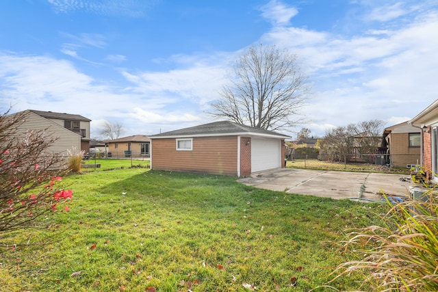 view of yard with a garage and an outbuilding