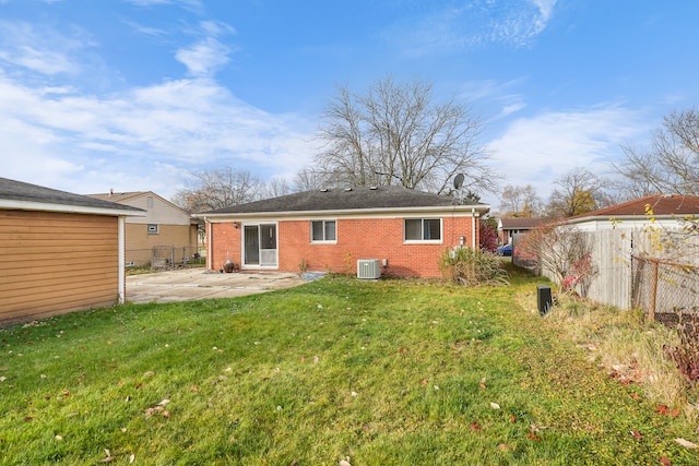 back of property with a patio, a yard, and central AC unit