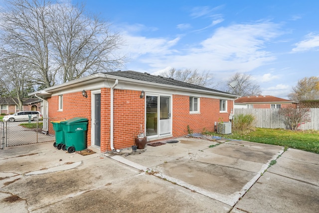 back of property with a patio area and central air condition unit