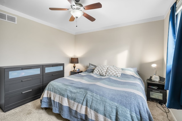 bedroom with light carpet, ornamental molding, and ceiling fan