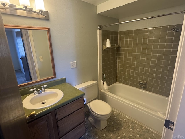 full bathroom with tiled shower / bath, vanity, and toilet